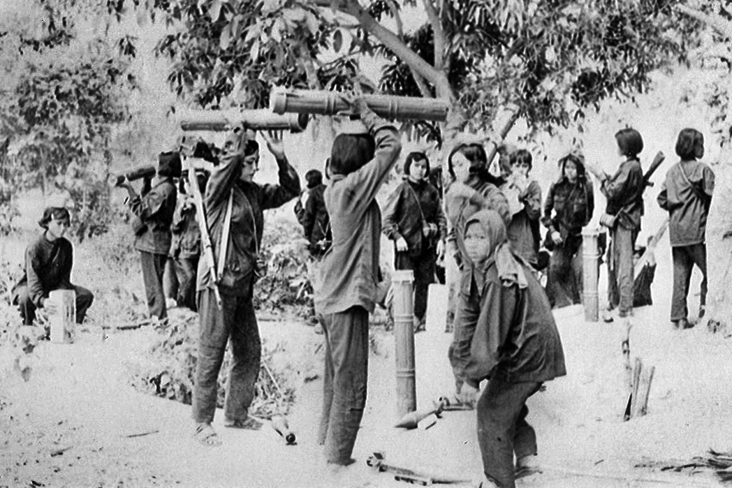 Women hold up rocket launchers