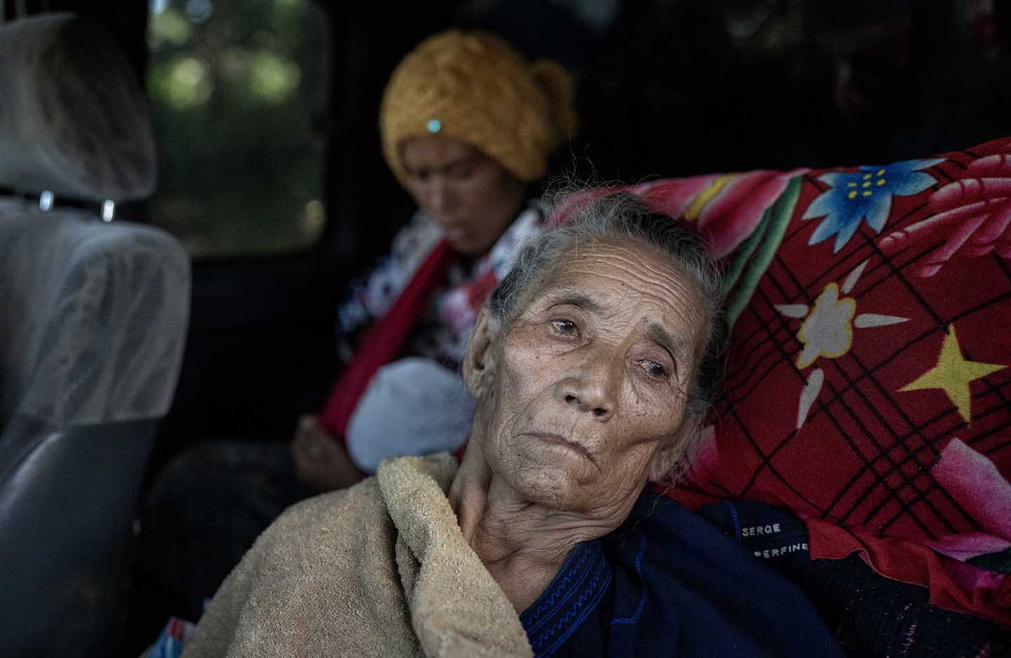 Elderly woman stares longingly out of a car window