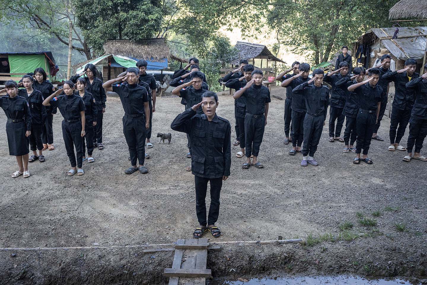 Police force members stand in rank and file and salute