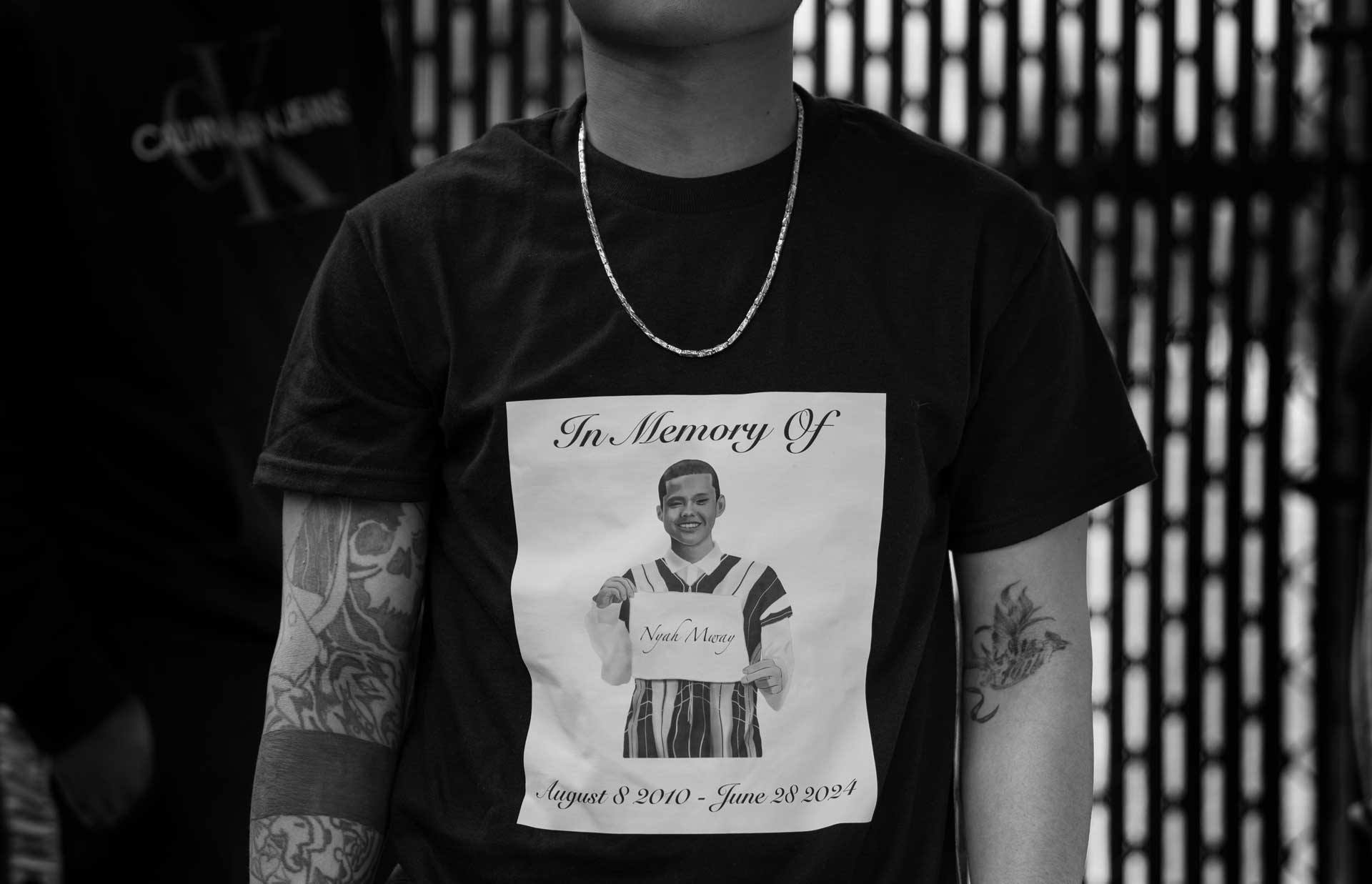 A Karen youth wears a T-shirt with Nyah Mway’s portrait as members of the community gather ahead of a memorial service for Nyah Mway in Utica, New York, July 6, 2024.