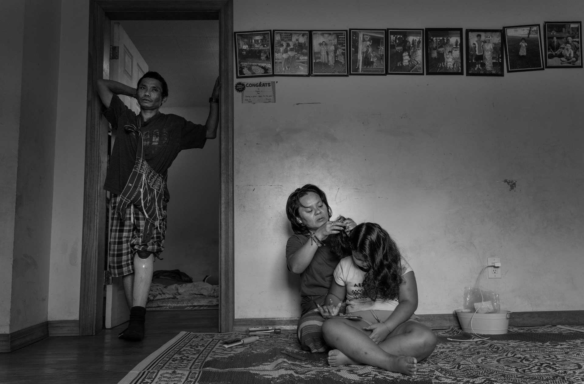 Nyah Mway’s mother Chee War, father Ka Lee Wan, and little sister Paw War at their home in Utica, New York, Aug. 18, 2024.