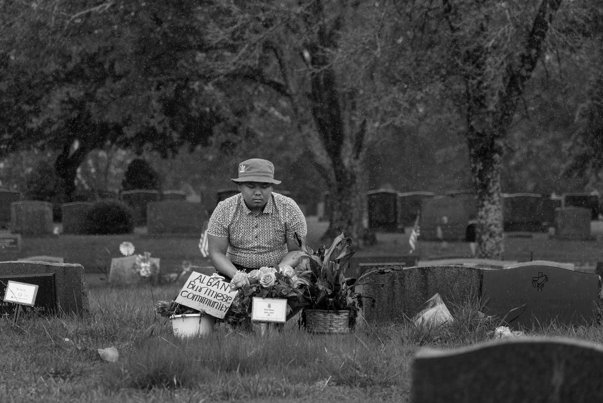 Thoung Oo, Nyah Mway’s eldest brother, visits Nyah’s grave in Utica, New York, Aug. 19, 2024. The 19-year-old has visited his brother’s grave frequently since the family buried him on July 6, 2024. “I talk to him, I tell him how much I missed him” he said. 