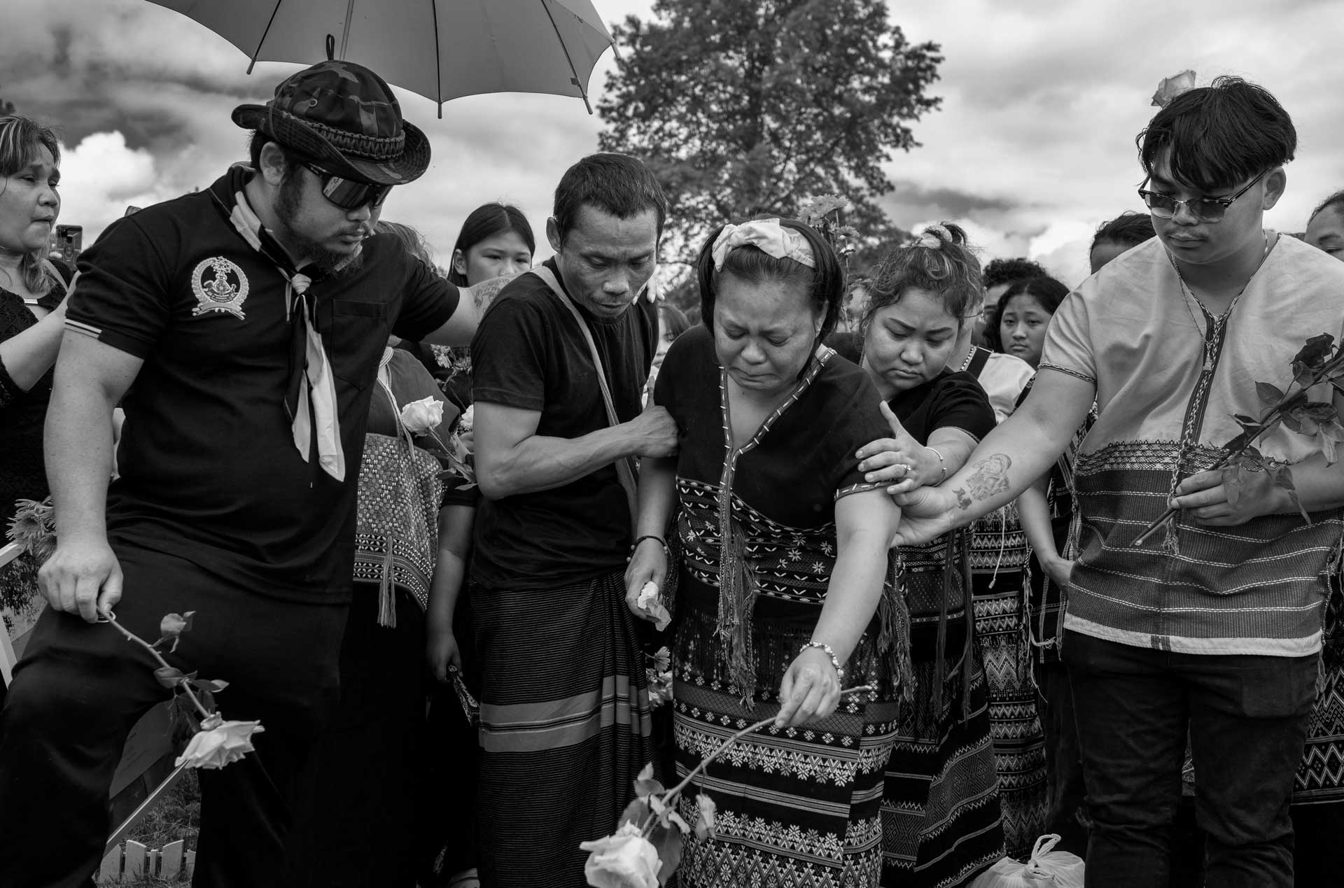 Nyah Mway’s father Ka Lee Wan comforts his wife Chee War as she places a flower at their son’s burial site in Utica, New York, July 6, 2024.