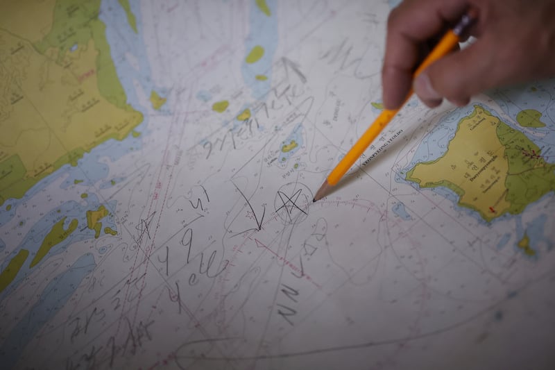 Lee Rae-jin, the older brother of a South Korean fisheries official who was fatally shot and burned at sea by North Korean soldiers in 2020, points out where he believed his brother was killed, in a marine chart showing Northern Limit Line (NLL) during an interview with Reuters in Ansan, South Korea, Aug. 8, 2022.