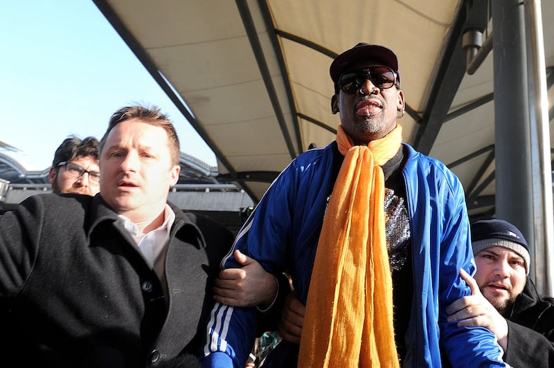 Canadian businessman Michael Spavor (L) walks with former U.S. basketball player Dennis Rodman after arriving from North Korea at Beijing International Airport in Beijing, Jan.13, 2014. Credit: AFP