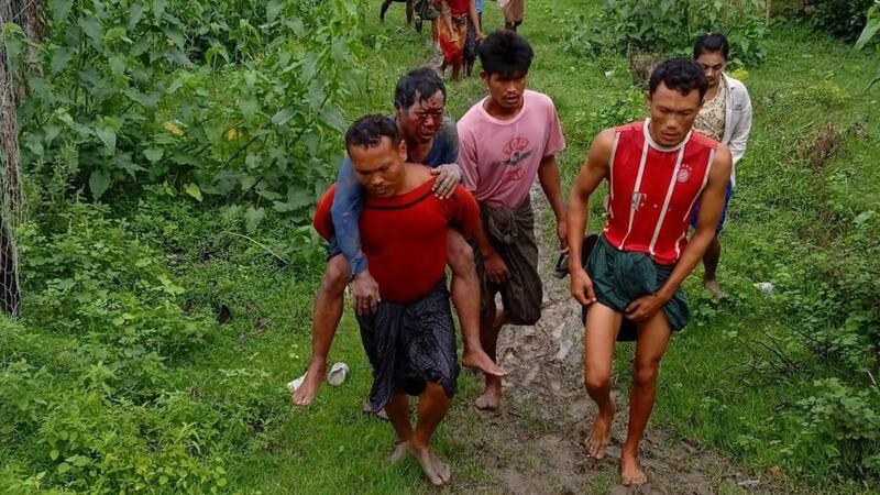 Residents assist a person injured by a landmine in Rathedaung township's Thar Si Htaunt village, June 17, 2022. Credit: Citizen journalist