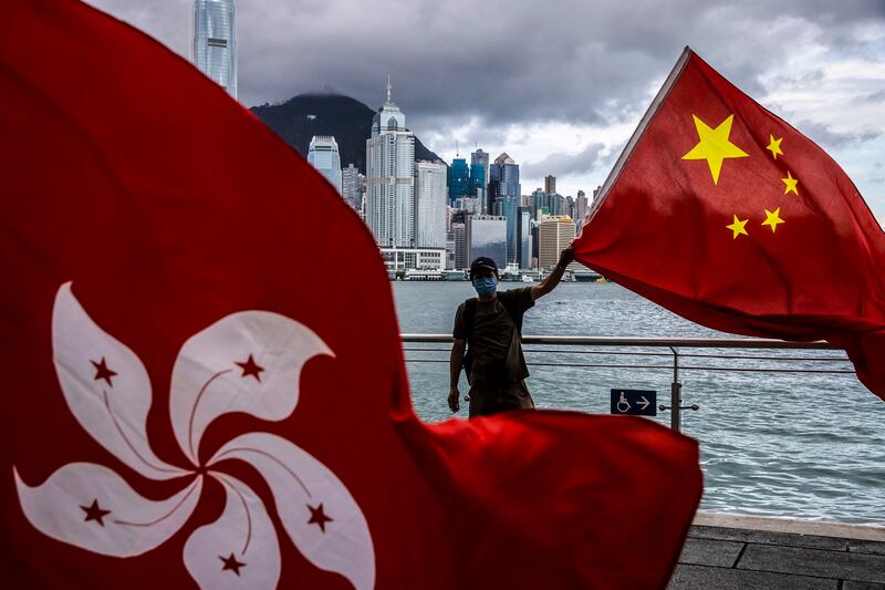 A man waves the Chinese flag to celebrate the 25th anniversary of the city's handover from Britain to China, in Hong Kong, July 1, 2022. Credit: AFP