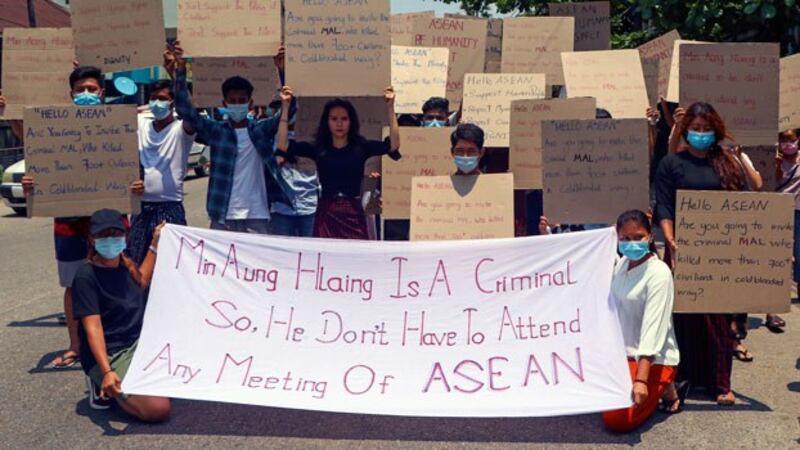 myanmar-protesters-asean-signs-yangon-arp20-2021.jpg