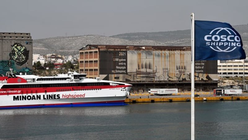 A ship sits in front of old warehouses in the Greek port of Piraeus, which is being expanded and transformed by Chinese state-owned shipping giant Cosco under China's Belt and Road Initiative, in Athens, Greece, Oct. 18, 2018. 