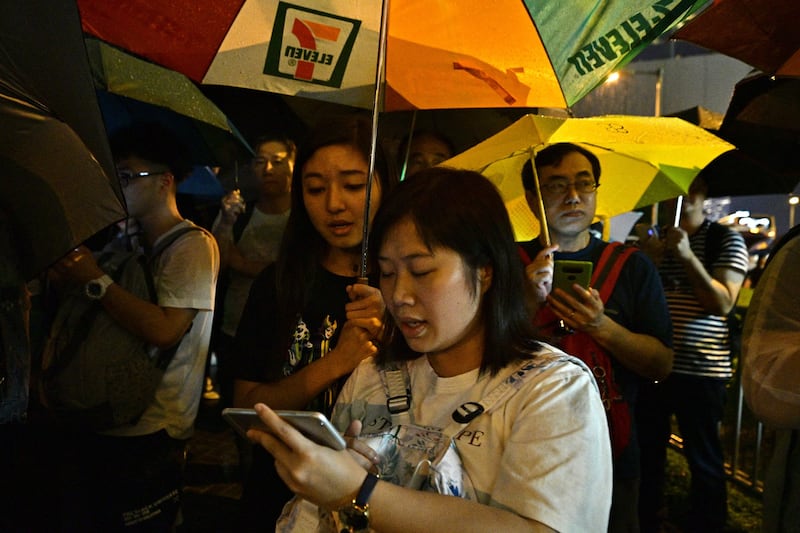 A group of Christians sing hymns in a peaceful protest against a plan to allow extraditions to the mainland, in Hong Kong on June 11, 2019. (Anthony Walace/AFP)