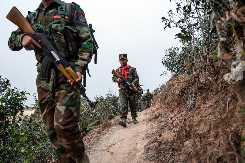 Ethnic rebel group Ta'ang National Liberation Army patrol near Namhsan Township in Myanmar's northern Shan State. (AFP)