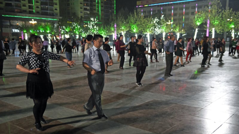 Han Chinese couples dance in a square in Hotan, northwestern China's Xinjiang region, in a file photo. Credit: AFP