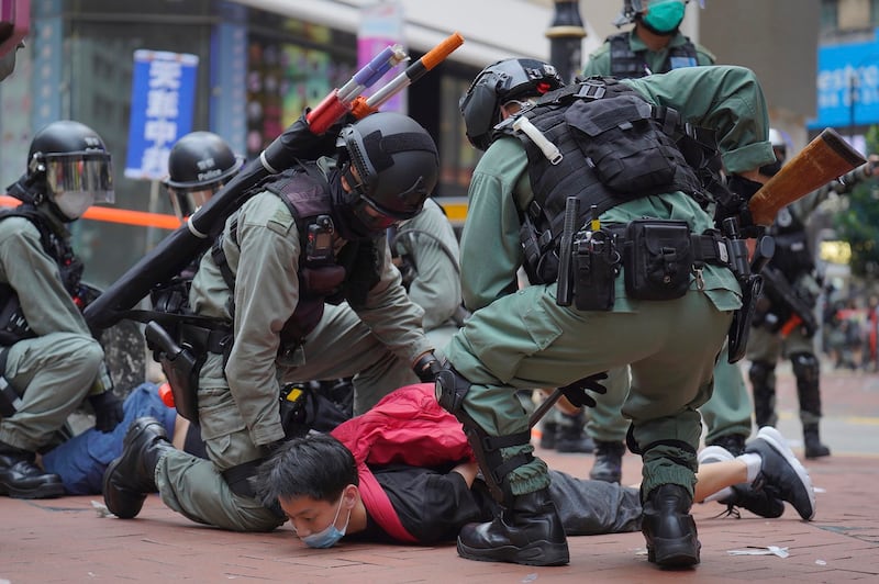 Riot in Hong Kong police detain a protester during a demonstration against Beijing's national security legislation, May 24, 2020. (Vincent Yu/AP)