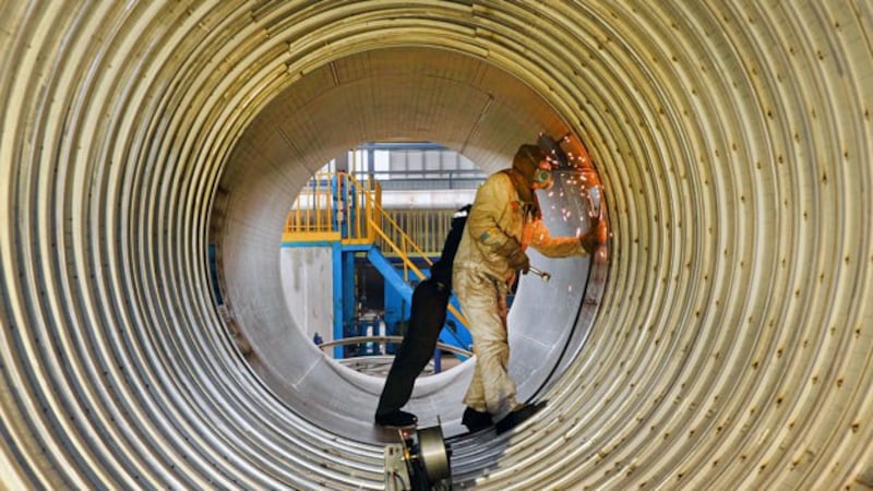 A worker welds a liquefied natural gas tank at a factory in Nantong, eastern China's Jiangsu province, March 14, 2019.