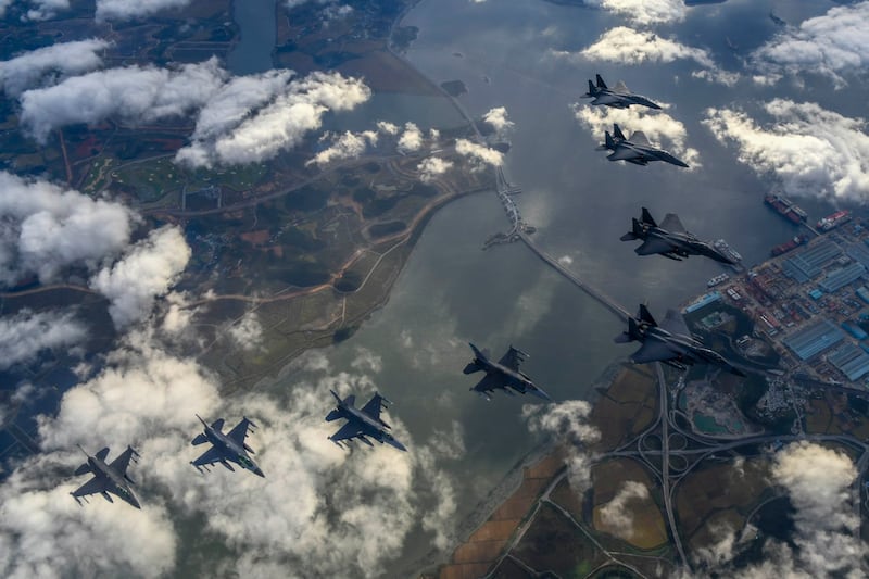 In this photo provided by South Korea Defense Ministry, South Korean Air Force's F15K fighter jets and U.S. Air Force's F-16 fighter jets, fly in formation during a joint drill in an undisclosed location in South Korea, Tuesday, Oct. 4, 2022. Credit: South Korea Defense Ministry via AP