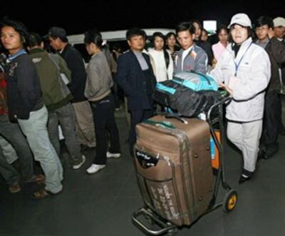 Một số công nhân đợi chuyến bay đi lao động nước ngoài. AFP