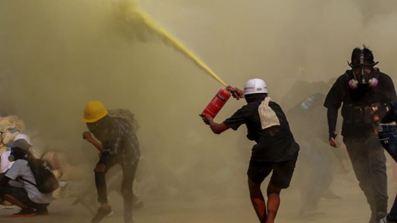 myanmar-anti-coup-protester-fire-extinguisher-yangon-mar17-2021.jpg