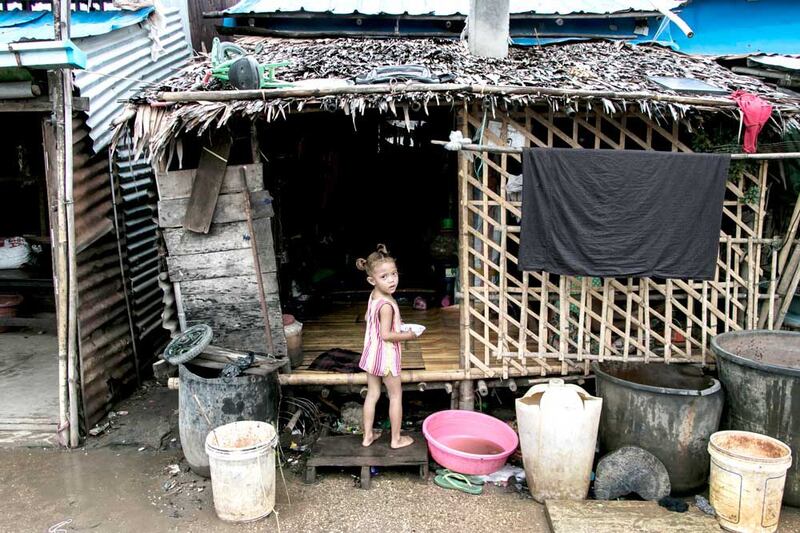 A girl plays in front of her home. (AFP)