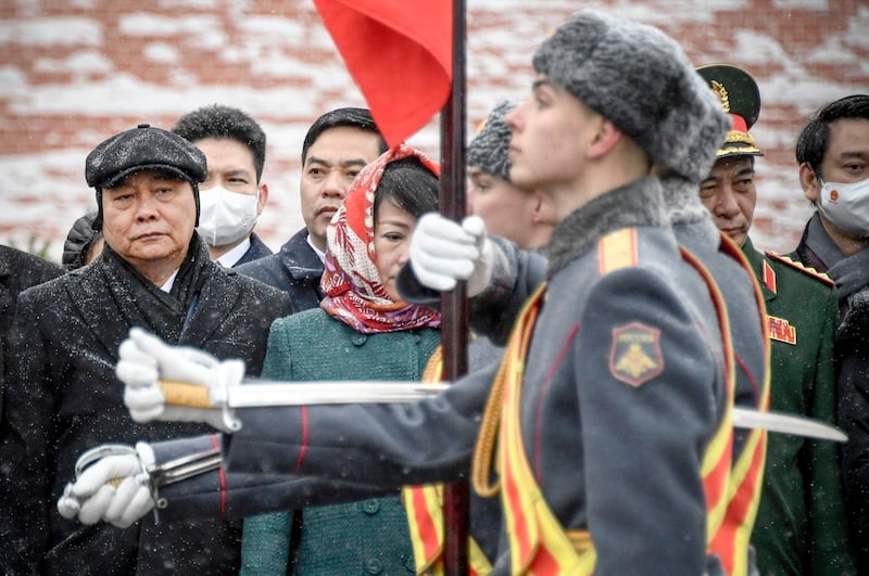 Vietnamese President Nguyen Xuan Phuc, left, attends a wreath-laying ceremony at the Tomb of the Unknown Soldier in Moscow, Russia, Wednesday, Dec. 1, 2021. credit: Pool Photo via AP.