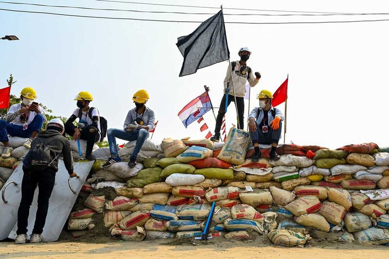 As the number of dead and wounded climbs, protesters build larger and thicker barricades, such as this one in Yangon's Hlaing Tharyar township. (AFP)