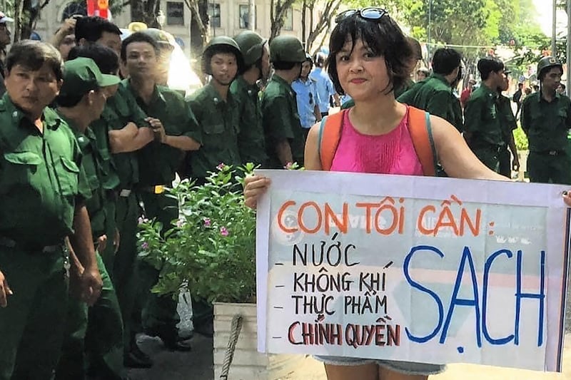 Vietnamese environment activist Hoang Thi Minh Hong holding a banner during a protest in Ho Chi Minh City in 2017.