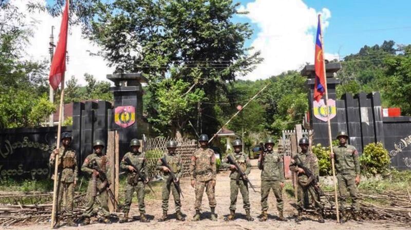 Arakan Army fighters pose outside a Myanmar junta military headquarters near Ann town after capturing it in this image released Nov. 13, 2024.