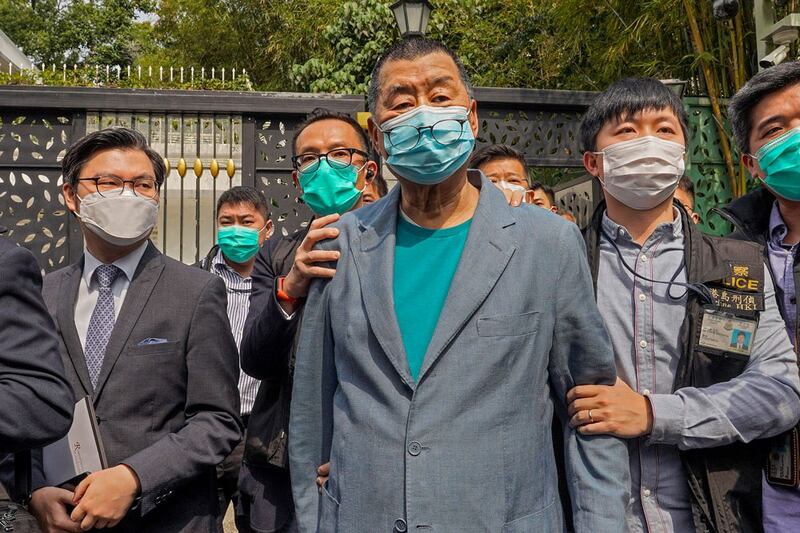 Hong Kong media tycoon Jimmy Lai, center, is arrested at his home in Hong Kong. (Associated Press)