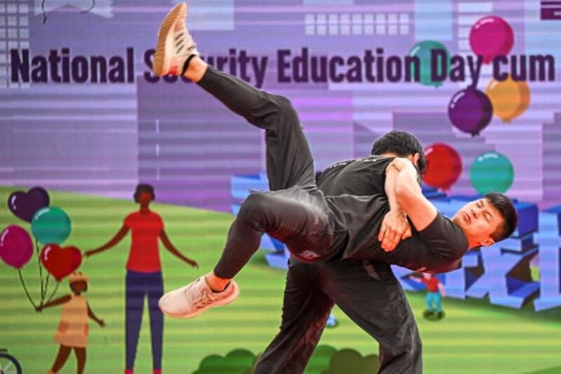 Two men perform unarmed combat at a Police College Open Day, part of National Security Education Day, in Hong Kong, April 13, 2024. (Peter Parks/AFP)