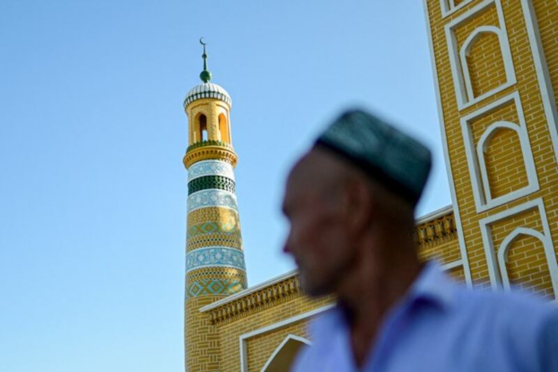 A Uyghur passes before the Id Kah Mosque in Kashgar city in northwestern China's Xinjiang region, July 13, 2023. (Pedro Pardo/AFP)