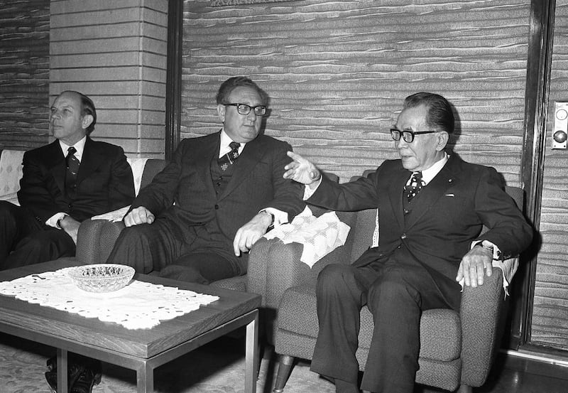 Japanese Prime Minister Takeo Miki gesticulates as he talks with Secretary of State Henry Kissinger in Tokyo at Miki's official residence, Dec. 8, 1975. (Koichiro Morita/AP)