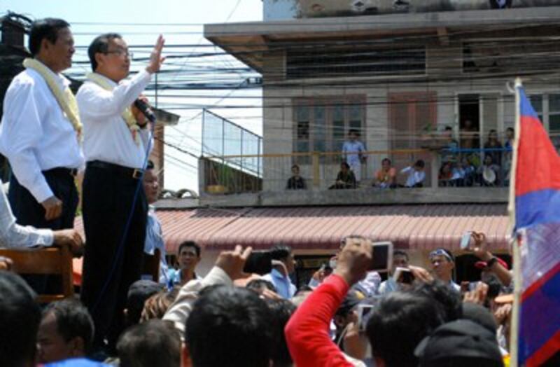 CNRP leaders Sam Rainsy and Kem Sokha address supporters outside the party headquarters, March 30, 2014. Photo credit: RFA. 