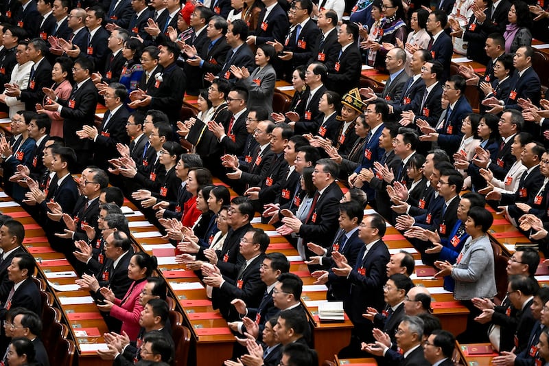 Delegates applaud during the closing session of the 14th National People's Congress at the Great Hall of the People in Beijing on March 11, 2024. (Wang Zhao/AFP)