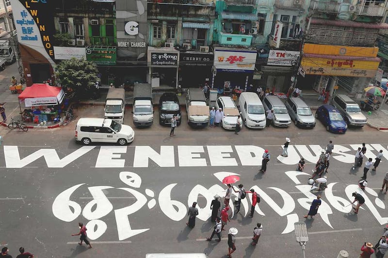 The message “We need justice” is visible from the upper floors of surrounding buildings. (RFA)