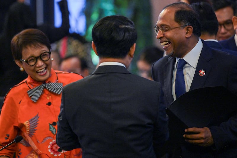 Indonesia's Foreign Minister Retno Marsudi, left shares a light moment with Laos' Foreign Minister Saleumxay Kommasith and Malaysia's Foreign Minister Zambry Abdul Kadir during the ASEAN Foreign Ministers' meeting in Jakarta, July 13, 2023. Credit: Bay Ismoyo/Pool via Reuters