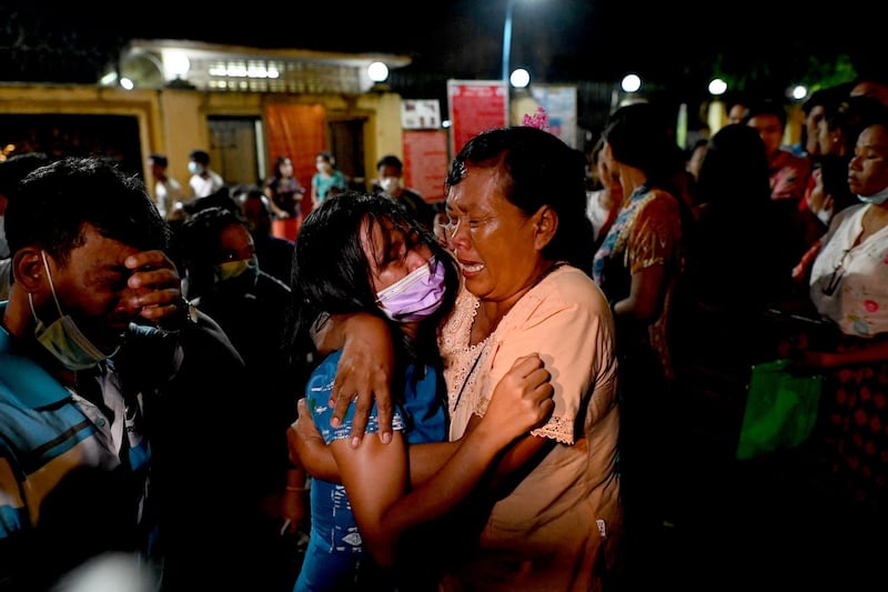 A woman is reunited with her waiting mother outside Insein Prison in Yangon following her release as part of a general amnesty, Oct. 18, 2021. AFP