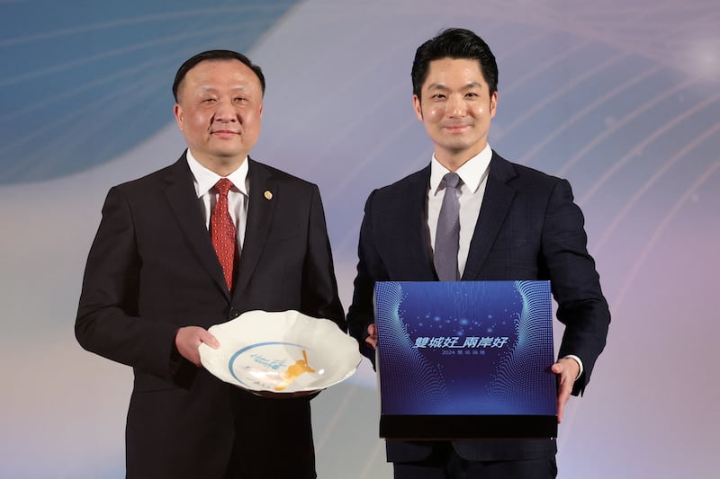 Shanghai Vice Mayor Hua Yuan and Taipei Mayor Chiang Wan-an pose for photo at a dinner before the annual city forum in Taipei, Taiwan, Dec. 16, 2024.