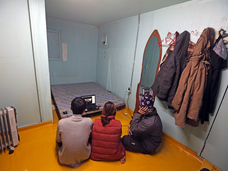 Cambodian workers participate in an online interview in a shipping container, that is used as their home, installed at a farm in Pocheon, South Korea on Feb. 8, 2021.