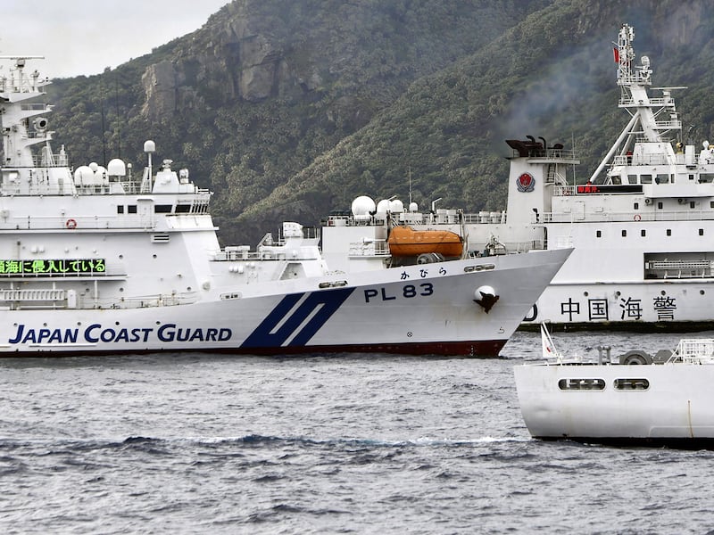 A China Coast Guard vessel sails near the Japan Coast Guard vessel Kabira, left, off Uotsuri Island, one of a group of disputed islands called Senkaku Islands, also known in China as Diaoyu Islands, in the East China Sea, on April 27, 2024.