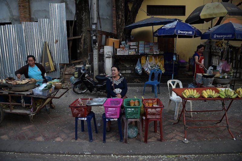 In this Feb. 9, 2015 photo, street food vendors wait for customers in Vientiane. Credit: Christophe Archambault/AFP)