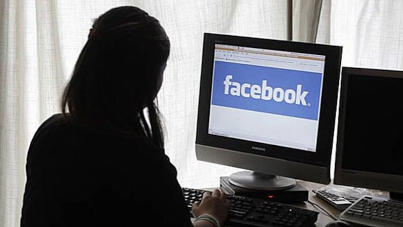 A Lao woman reads Facebook on her computer in an undated photo.