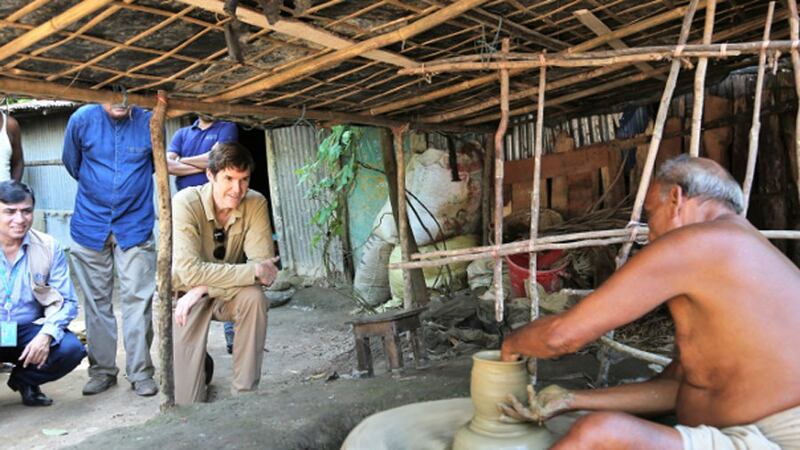 Earl R. Miller, the U.S. ambassador to Bangladesh, watches a Bangladeshi man make clay pots during a visit to Cox's Bazar district, Sept. 15, 2019.