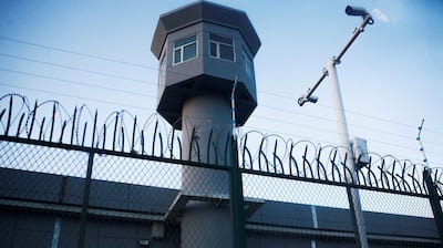 A guard watchtower rises along a perimeter fence of what is officially known as a 'vocational center' in Urumqi's Dabancheng district, in the Xinjiang Uyghur Autonomous Region, Sept. 4, 2018.