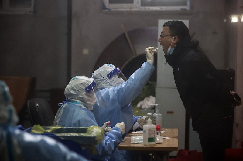 A resident undergoes a nucleic acid test for the Covid-19 coronavirus in Changchun in China's northeastern Jilin province, March 11, 2022. Credit: AFP