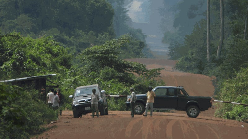 Authorities man a checkpoint for trucks hauling illegally cut timber out of a protected forest area in Cambodia in an undated photo. Credit: Amnesty International/Private