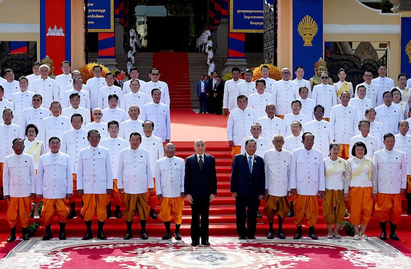 Cambodia's King Norodom Sihamoni, front center, and members of Cambodia's government pose with newly elected members of parliament during the opening ceremony at the National Assembly building in Phnom Penh on Aug. 21, 2023. (Tang Chhin Sothy/AFP)