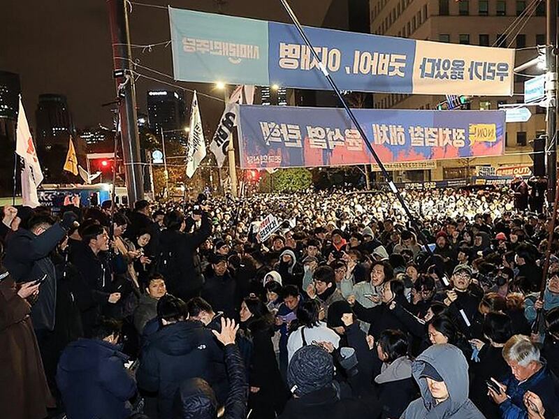 People gather in front of the National Assembly in Seoul on Dec. 4, 2024, after South Korea President Yoon Suk Yeol declared emergency martial law.