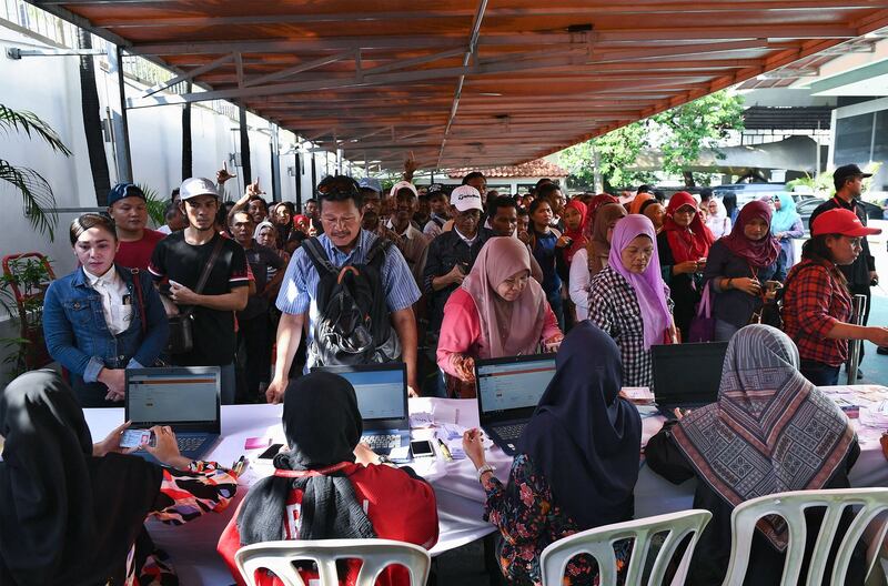 Officials check documentation of Indonesians living in Malaysia as they stand to cast overseas ballots ahead of the Indonesia's general election, in Kuala Lumpur, April 14, 2019. (Mohd Rasfan/AFP)