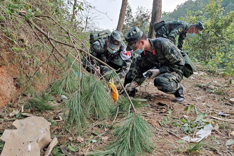 Paramilitary police officers conducting a search at the site of the China Eastern Airlines plane crash in Tengxian county, Wuzhou city, in China's southern Guangxi region, March 21, 2022. Credit: AFP