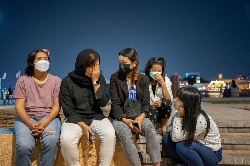 Stranded migrant workers from left, Moe Moe Aye, Ma Nwe, Ei Nge, Htay Htay Myint and Theingi Soe meet near Dubai Creek. Each woman said she had been exploited by hiring agents and abused by employers. Photo by Gemunu Amarasinghe