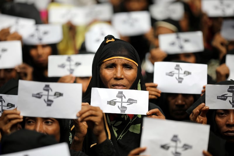 Rohingya refugee women hold placards as they take part in a protest at the Kutupalong refugee camp to mark the first year of their exodus in Cox’s Bazar, Bangladesh, Aug. 25, 2018.